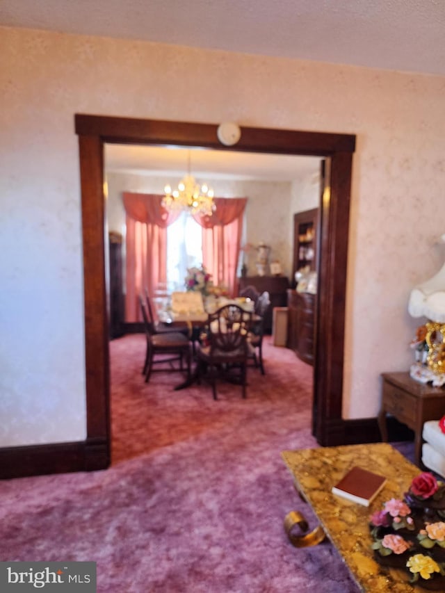 dining room with carpet and a notable chandelier