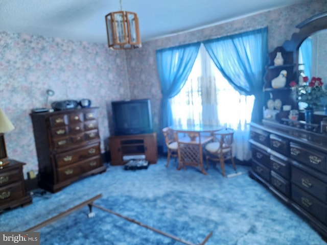 carpeted bedroom featuring an inviting chandelier and multiple windows