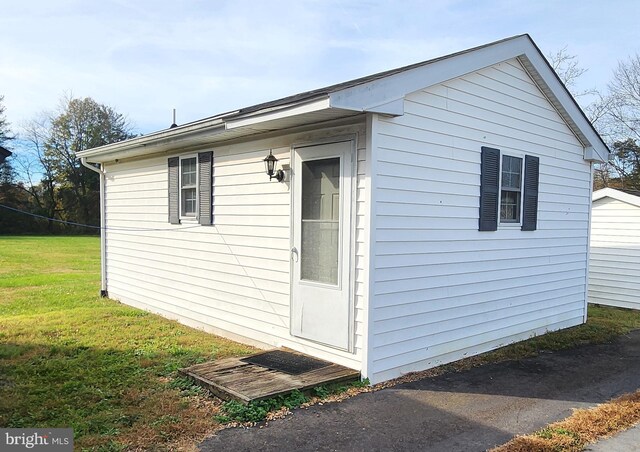 view of home's exterior with a yard