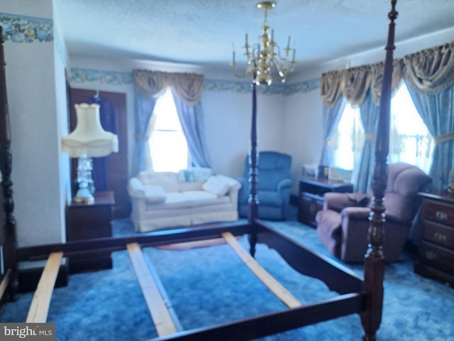 carpeted bedroom featuring a notable chandelier, a textured ceiling, and multiple windows