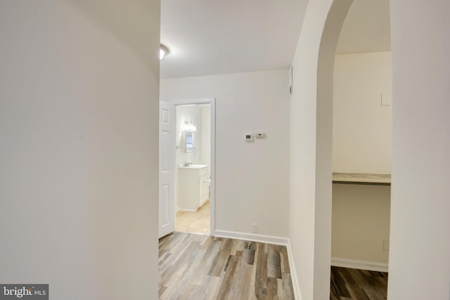 hall featuring light hardwood / wood-style flooring and sink