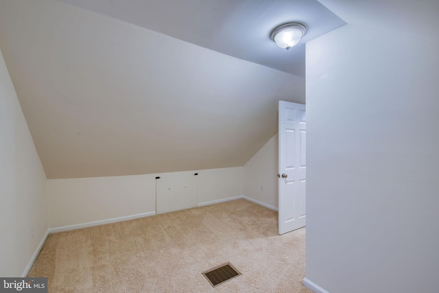 bonus room featuring light colored carpet and lofted ceiling