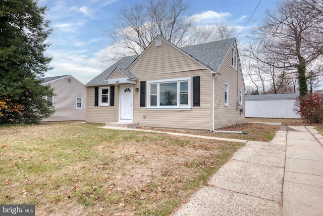 bungalow-style house featuring a front lawn