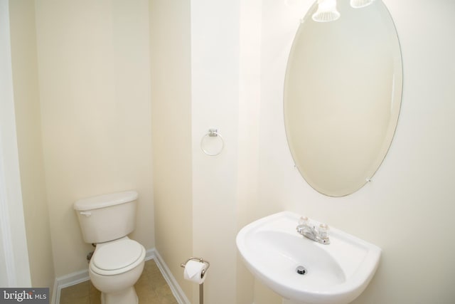 bathroom featuring sink, tile patterned floors, and toilet