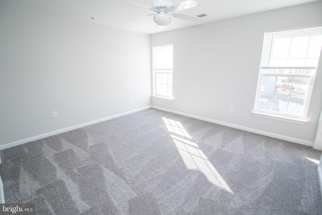 unfurnished room featuring ceiling fan and carpet