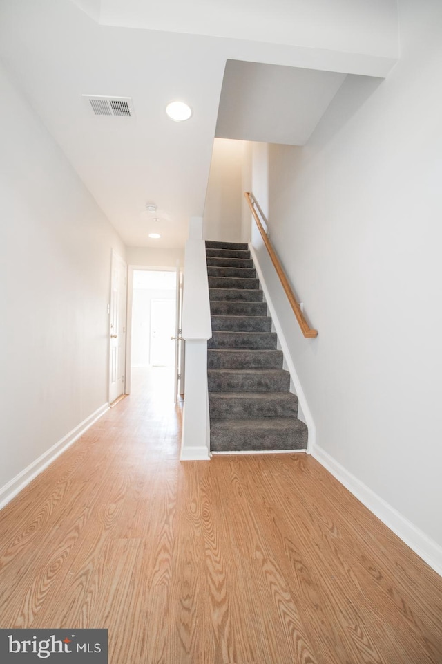 staircase featuring wood-type flooring