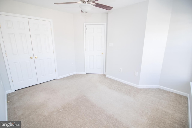 unfurnished bedroom featuring ceiling fan and light carpet