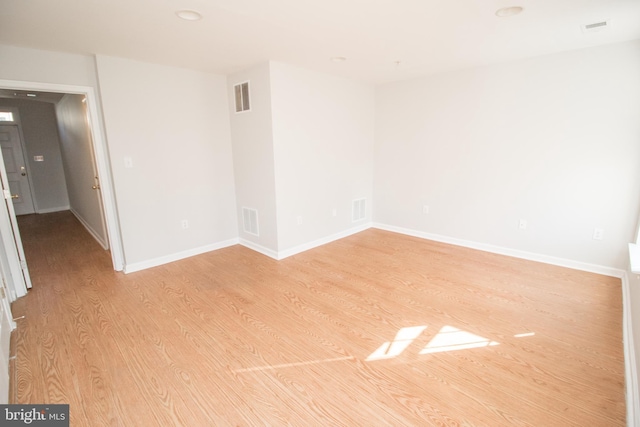 empty room with light hardwood / wood-style floors