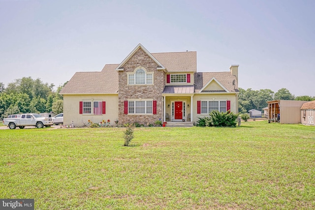 view of front facade featuring a front yard and a storage shed