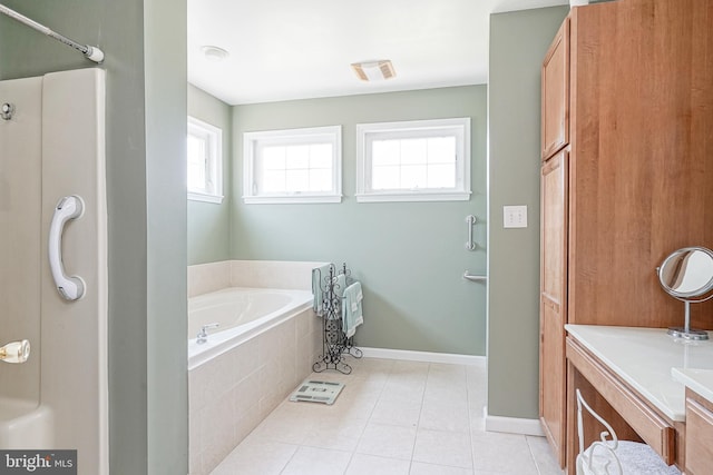 bathroom with tile patterned flooring, vanity, and shower with separate bathtub