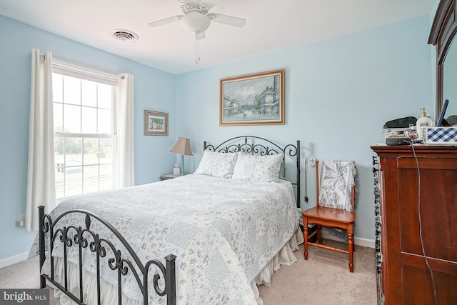 bedroom featuring light carpet and ceiling fan