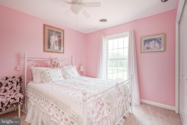 bedroom featuring ceiling fan, light colored carpet, and a closet