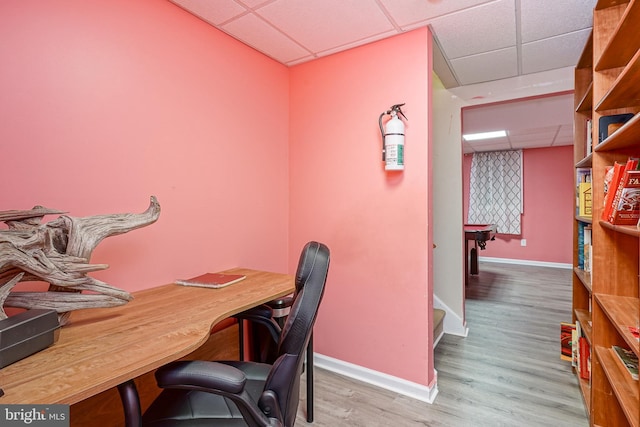 office with a paneled ceiling and hardwood / wood-style flooring