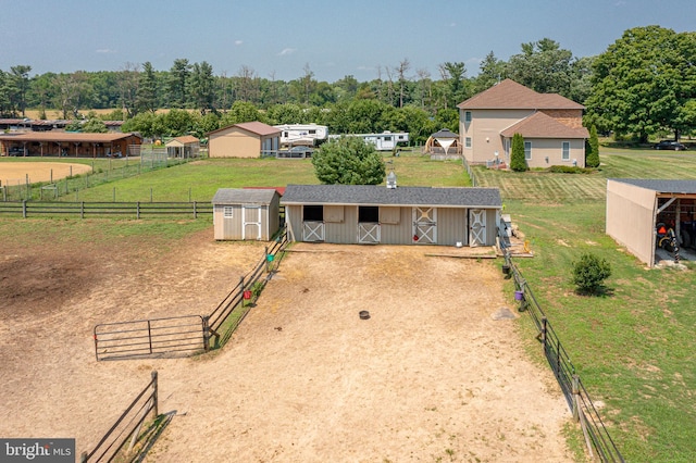 birds eye view of property with a rural view