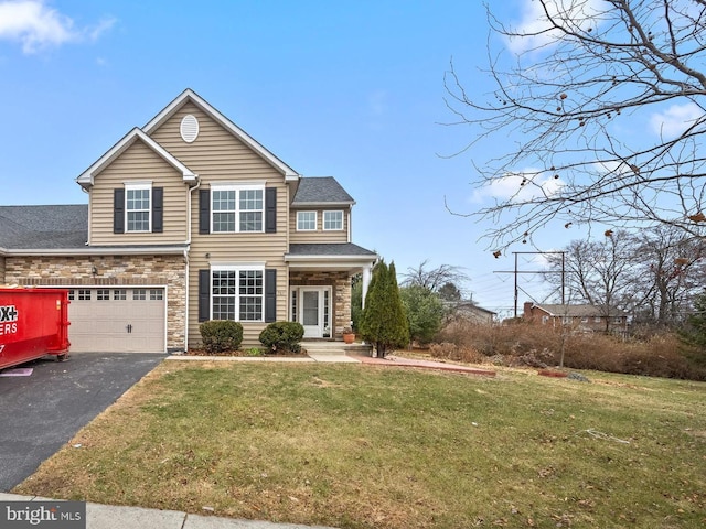 view of front of house featuring a front lawn and a garage