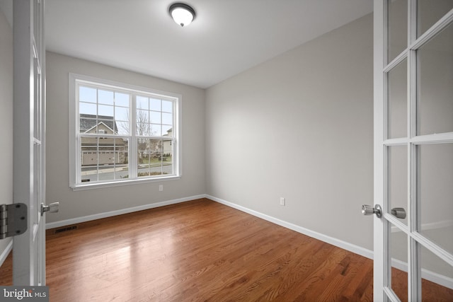 spare room featuring hardwood / wood-style floors