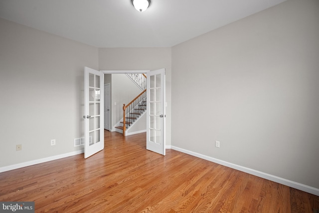 unfurnished room with light hardwood / wood-style flooring and french doors