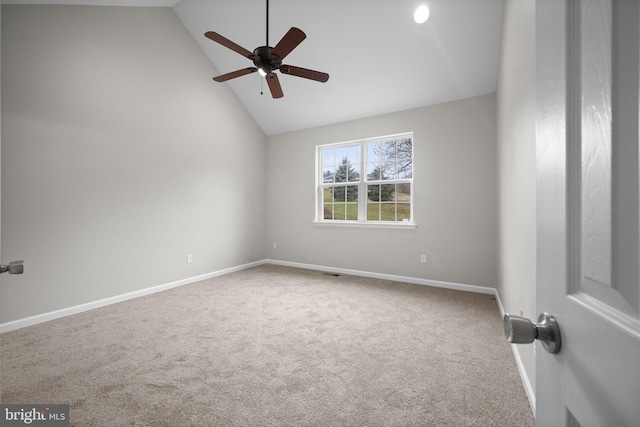 carpeted spare room featuring high vaulted ceiling and ceiling fan