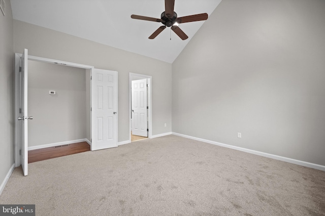 unfurnished bedroom with ceiling fan, carpet floors, and high vaulted ceiling