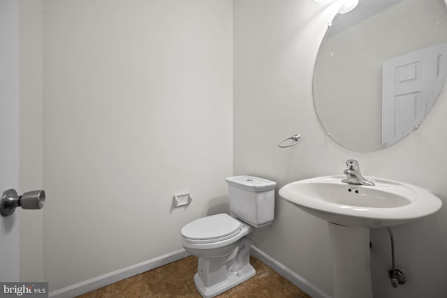 bathroom featuring tile patterned flooring and toilet