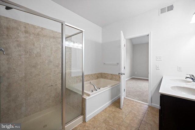 bathroom featuring tile patterned flooring, vanity, and shower with separate bathtub