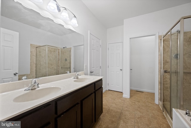 bathroom with tile patterned floors, vanity, and a shower with shower door