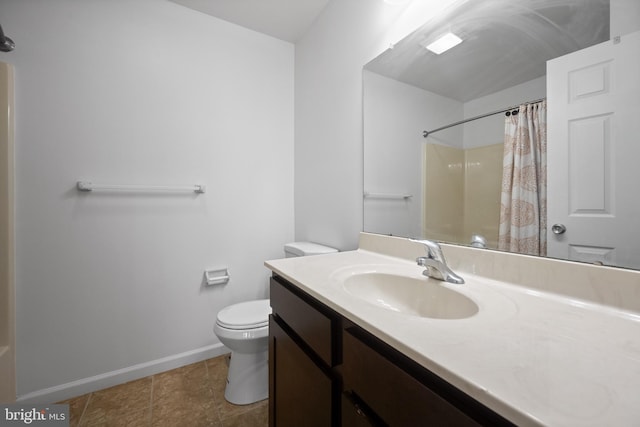 bathroom with tile patterned floors, toilet, vanity, and walk in shower