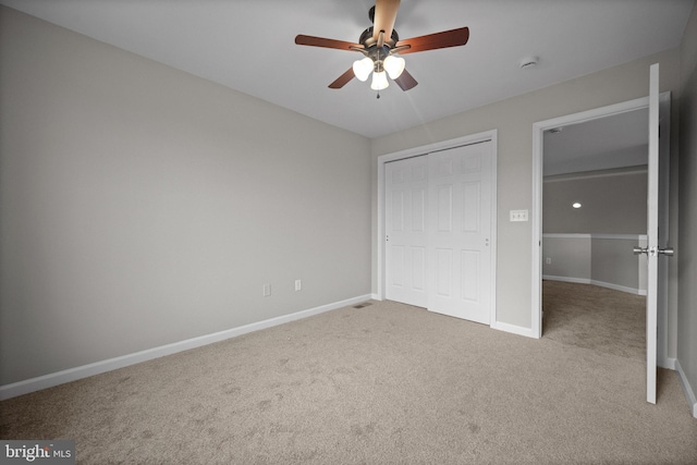 unfurnished bedroom with ceiling fan, a closet, and light colored carpet