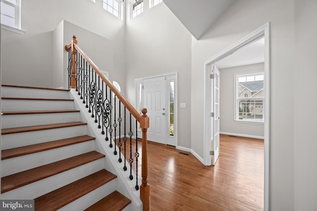 entryway featuring a high ceiling and light wood-type flooring