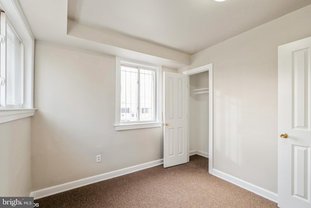 unfurnished bedroom with light carpet and a closet