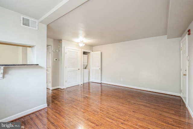 unfurnished living room featuring hardwood / wood-style floors