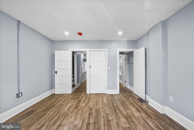 unfurnished bedroom featuring dark hardwood / wood-style floors and a closet