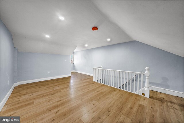 bonus room featuring vaulted ceiling and light hardwood / wood-style flooring