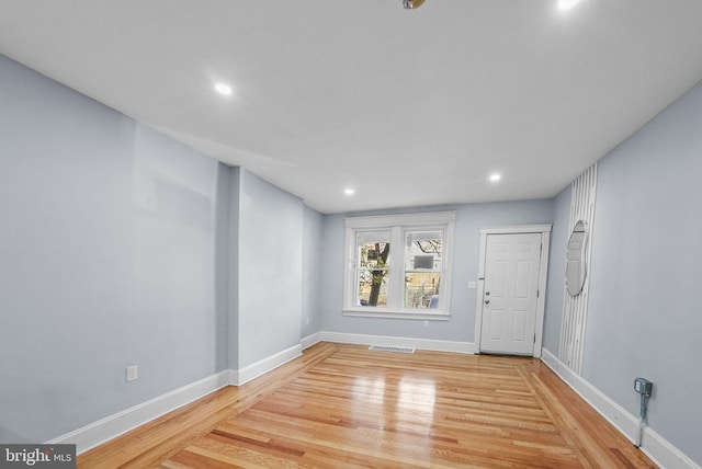 spare room with light hardwood / wood-style flooring