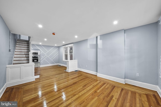 unfurnished living room with hardwood / wood-style flooring