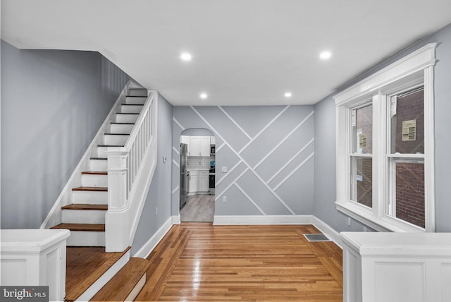 stairway featuring hardwood / wood-style floors