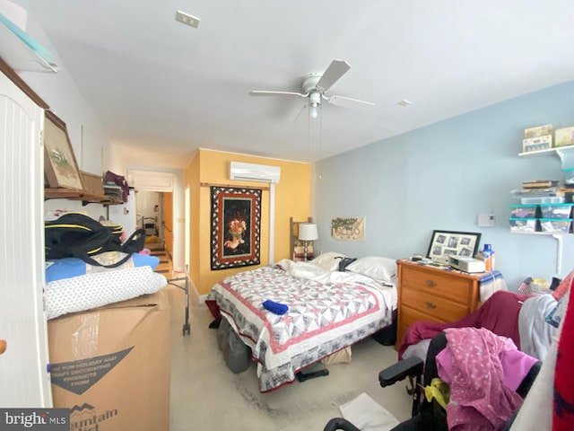 carpeted bedroom featuring ceiling fan and a wall mounted air conditioner