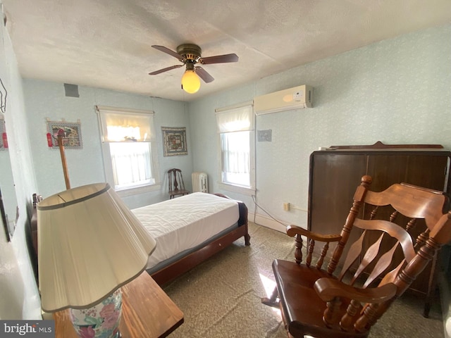 bedroom with a wall mounted AC, radiator heating unit, multiple windows, and ceiling fan