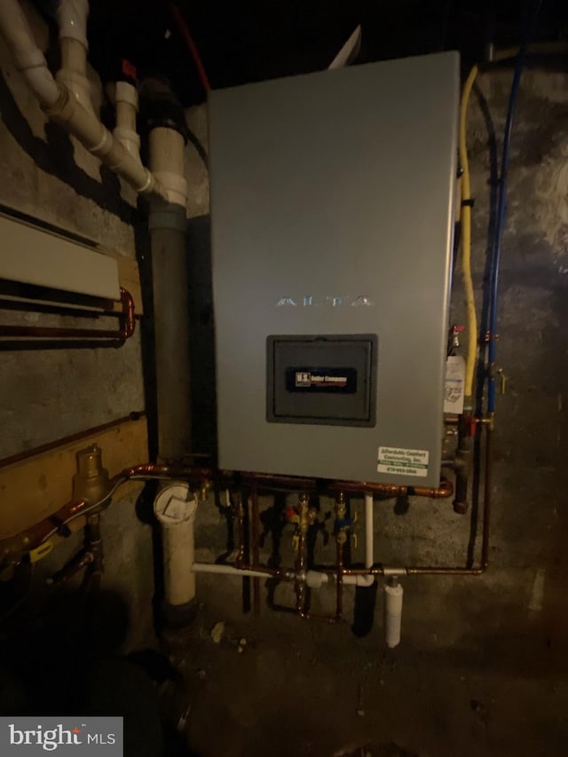 utility room featuring tankless water heater