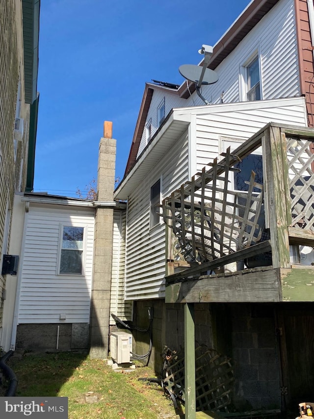 view of side of home featuring a wooden deck