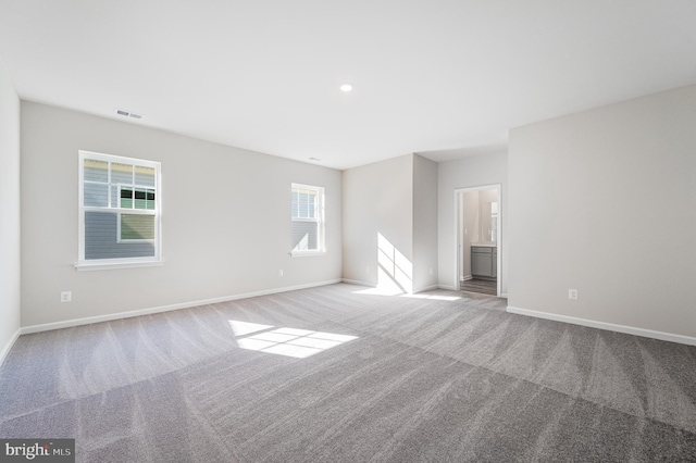 empty room with plenty of natural light and light colored carpet