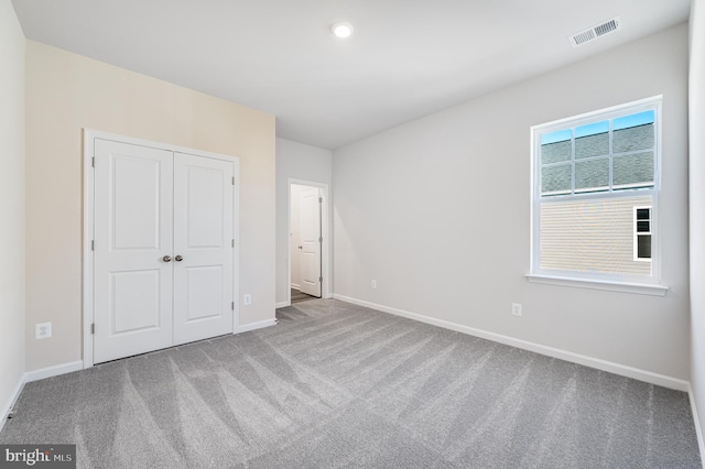 unfurnished bedroom featuring a closet and carpet floors