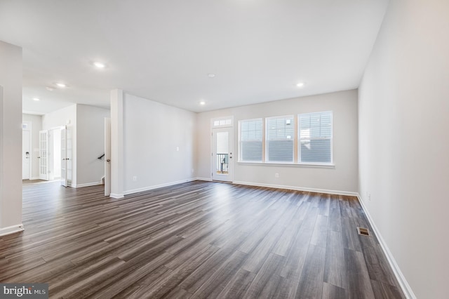 unfurnished room featuring dark hardwood / wood-style flooring