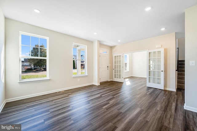 unfurnished room with dark hardwood / wood-style flooring and french doors