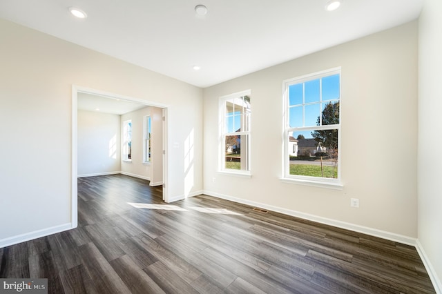 empty room with dark wood-type flooring