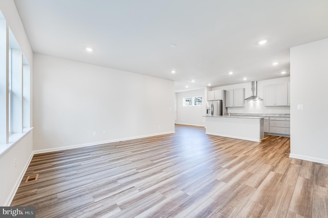 unfurnished living room featuring light hardwood / wood-style floors