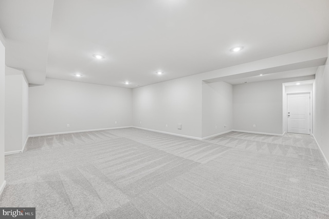 basement featuring light colored carpet