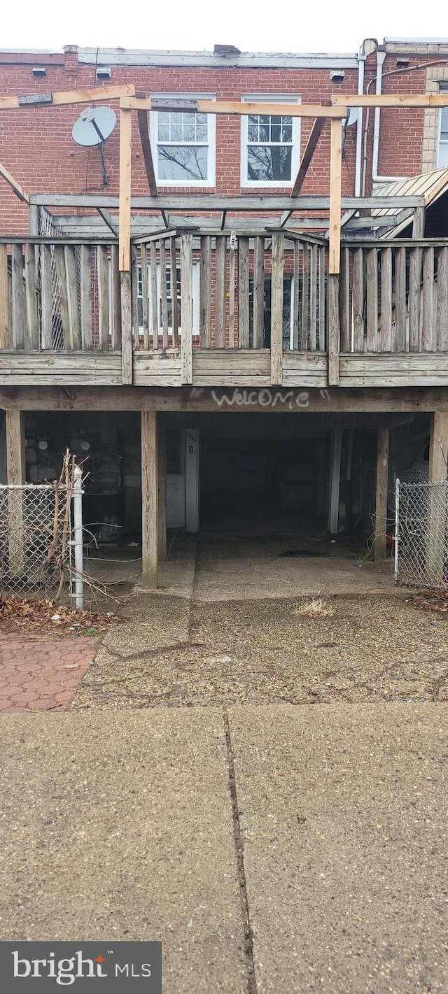 back of property featuring brick siding