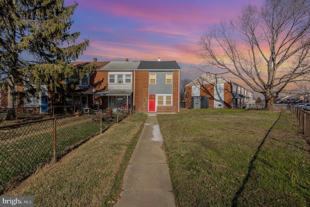 view of front of property with a yard