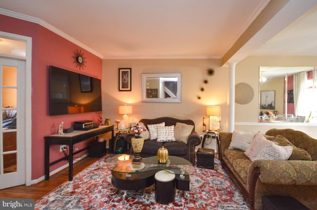 living room with decorative columns, ornamental molding, and hardwood / wood-style flooring